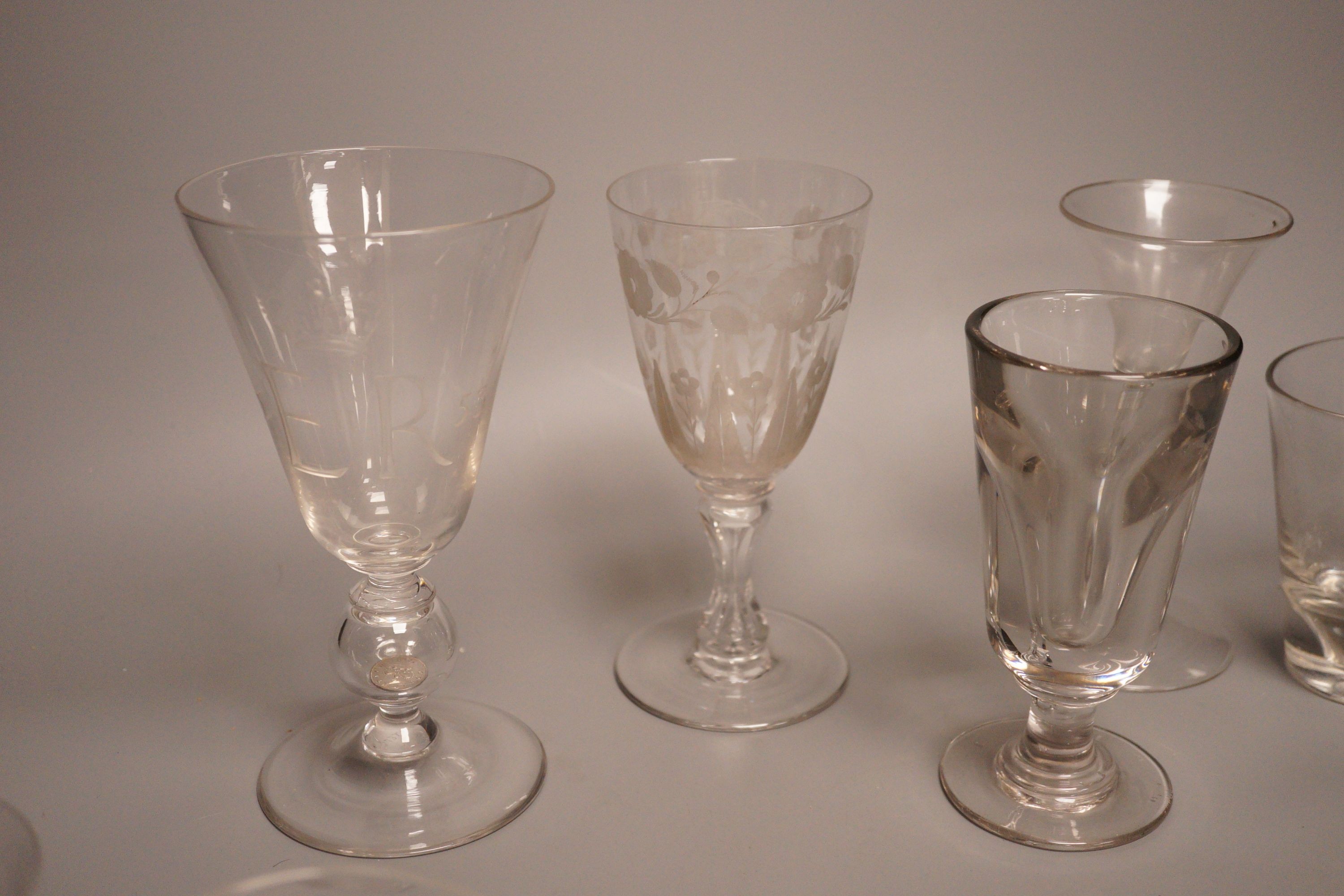 A group of eight 19th/20th century novelty or commemorative glasses, tallest 19.5 cm, including two deceptive glasses, a wheel engraved tumbler with hangman to the base etc.